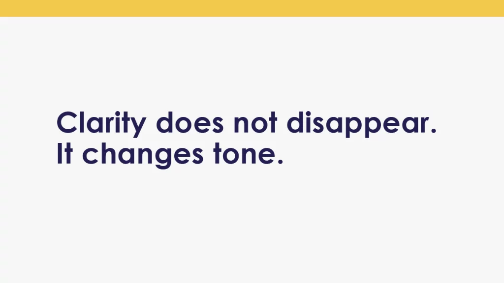 Body image with the words “Clarity does not disappear. It changes tone.” on a clean white background with a single gold band at the top.